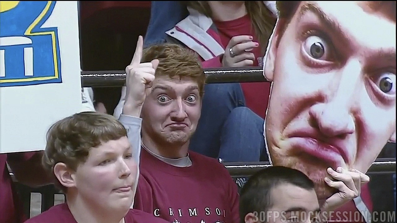 Illustration for article titled This Alabama Fan Holds A Giant, Bug-Eyed Cutout Of His Face At Games, And We're Scared